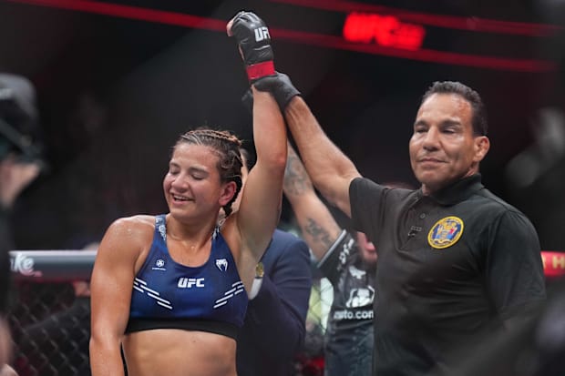 Ailin Perez (red gloves) celebrates defeating Joselyne Edwards (blue gloves) during UFC 302 at Prudential Center. 