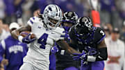 Dec 3, 2022; Arlington, TX, USA; Kansas State Wildcats wide receiver Malik Knowles (4) stiff arms TCU Horned Frogs safety Mark Perry (3) as he runs for a first down during the second quarter at AT&T Stadium. Mandatory Credit: Jerome Miron-Imagn Images