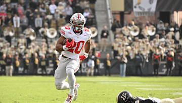 Nov 8, 2025; West Lafayette, Indiana, USA; Ohio State Buckeyes running back James Peoples (20) breaks a tackle from Purdue Boilermakers defensive back Hershey McLaurin (25) during the third quarter at Ross-Ade Stadium. Mandatory Credit: Marc Lebryk-Imagn Images