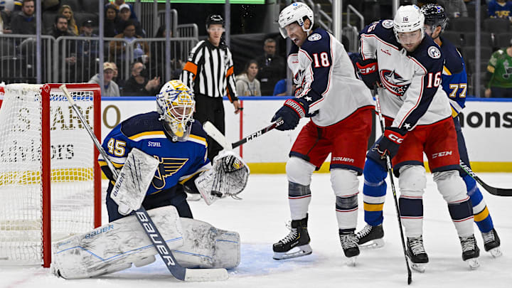 Sep 29, 2022; St. Louis, Missouri, USA;  St. Louis Blues goaltender Colten Ellis (45) defends the net against Columbus Blue Jackets forward James Neal (18) and forward Brendan Gaunce (16) during the third period at Enterprise Center. Mandatory Credit: Jeff Curry-Imagn Images