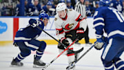 Sep 22, 2024; Toronto, Ontario, CAN;  Ottawa Senators forward Carter Yakemchuk (58) skates past Toronto Maple Leafs defenseman Jake McCabe (22) as he moves in to score the winning goal in overtime at Scotiabank Arena. Mandatory Credit: Dan Hamilton-Imagn Images