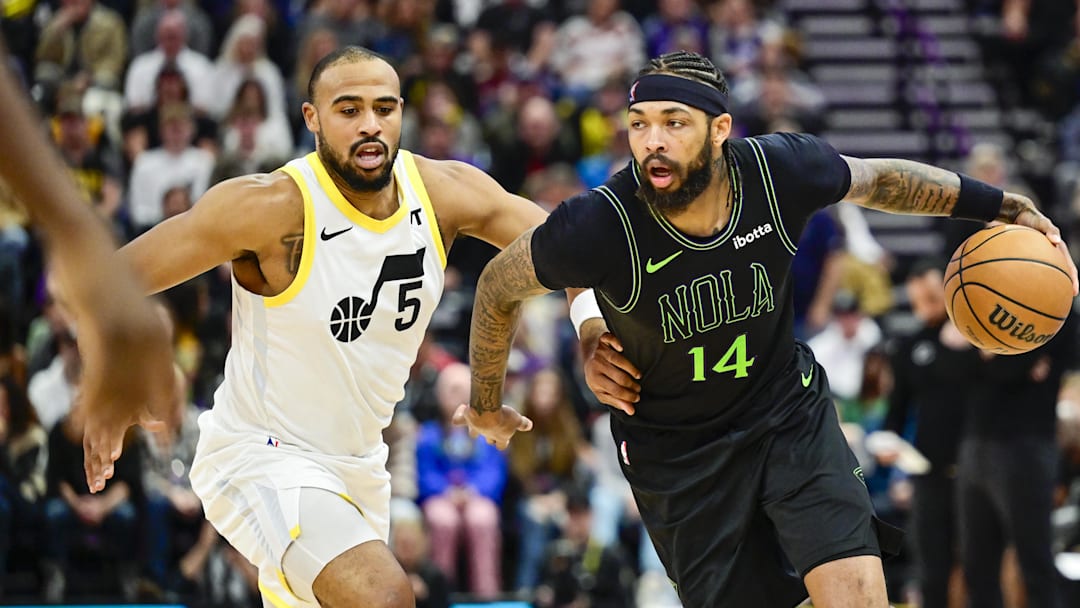 Nov 25, 2023; Salt Lake City, Utah, USA; New Orleans Pelicans forward Brandon Ingram (14) dribbles the ball around Utah Jazz guard Talen Horton-Tucker (5) during the second half at Delta Center.
