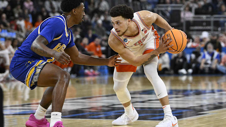 Mar 20, 2025; Providence, RI, USA; Clemson Tigers guard Chase Hunter (1) controls the ball against McNeese State Cowboys guard Brandon Murray (23) during the first half at Amica Mutual Pavilion. Mandatory Credit: Eric Canha-Imagn Images