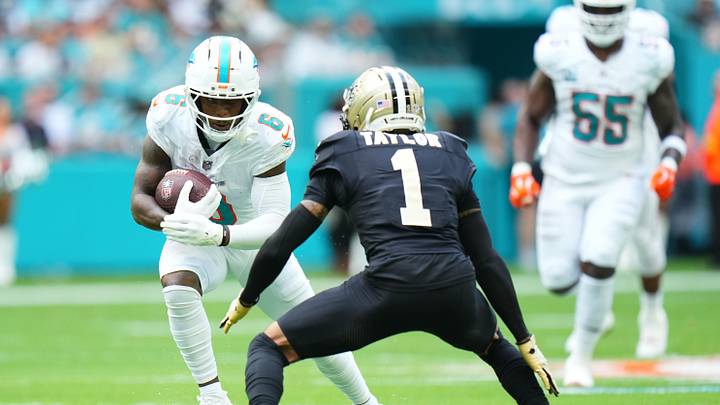 Nov 30, 2025; Miami Gardens, Florida, USA; Miami Dolphins wide receiver Malik Washington (6) runs after the catch as New Orleans Saints cornerback Alontae Taylor (1) defends during the first half at Hard Rock Stadium. Mandatory Credit: Rich Storry-Imagn Images
