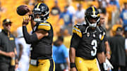 Sep 22, 2024; Pittsburgh, Pennsylvania, USA; Pittsburgh Steelers quarterback Justin Fields (2) warms up next to quarterback Russell Wilson (3) before a game against the Los Angeles Chargers at Acrisure Stadium. Mandatory Credit: Barry Reeger-Imagn Images