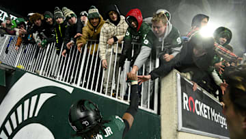 Nov 22, 2024; East Lansing, Michigan, USA;  fans scramble for souvenirs after the Michigan State Spartans beat the Purdue Boilermakers at Spartan Stadium. Mandatory Credit: Dale Young-Imagn Images