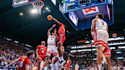 Mar 8, 2025; Lawrence, Kansas, USA; Kansas Jayhawks forward Flory Bidunga (40) rebounds over Arizona Wildcats guard KJ Lewis (5) during the first half at Allen Fieldhouse. Mandatory Credit: William Purnell-Imagn Images