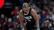 San Antonio Spurs point guard Chris Paul looks on.