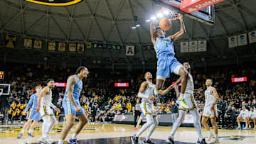 Feb 23, 2025; Wichita, Kansas, USA; Tulane Green Wave forward Kaleb Banks (1) dunks during the first half against the Wichita State Shockers at Charles Koch Arena. 