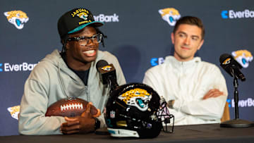 The Jacksonville Jaguars’ first-round pick, Colorado Buffaloes wide receiver and defensive back Travis Hunter, left, answers questions as General Manager James Gladstone, right, sits next to him during a press conference.