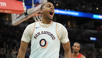 Apr 13, 2025; San Antonio, Texas, USA; San Antonio Spurs forward Keldon Johnson (0) reacts after scoring during the second half against the Toronto Raptors at Frost Bank Center.