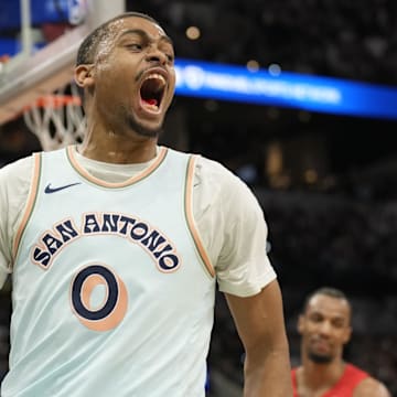 Apr 13, 2025; San Antonio, Texas, USA; San Antonio Spurs forward Keldon Johnson (0) reacts after scoring during the second half against the Toronto Raptors at Frost Bank Center.