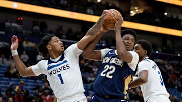 Dec 2, 2025; New Orleans, Louisiana, USA; Minnesota Timberwolves guard/forward Terrence Shannon Jr. (1) and forward Jaden McDaniels (3) defend against New Orleans Pelicans center Derik Queen (22) during the first half at Smoothie King Center. Mandatory Credit: Matthew Hinton-Imagn Images