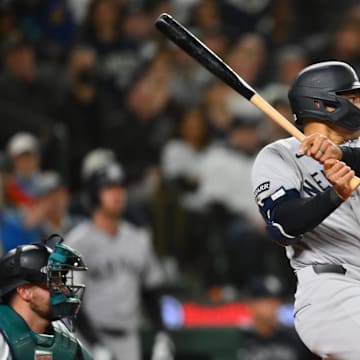 May 13, 2025; Seattle, Washington, USA; New York Yankees center fielder Trent Grisham (12) hits a single against the Seattle Mariners during the eighth inning at T-Mobile Park.