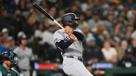 May 13, 2025; Seattle, Washington, USA; New York Yankees center fielder Trent Grisham (12) hits a single against the Seattle Mariners during the eighth inning at T-Mobile Park.