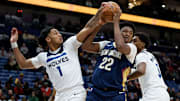 Dec 2, 2025; New Orleans, Louisiana, USA; Minnesota Timberwolves guard/forward Terrence Shannon Jr. (1) and forward Jaden McDaniels (3) defend against New Orleans Pelicans center Derik Queen (22) during the first half at Smoothie King Center.