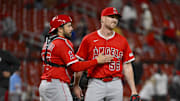 Apr 1, 2025; St. Louis, Missouri, USA;  Los Angeles Angels relief pitcher Ryan Zeferjahn (56) celebrates with catcher Travis d'Arnaud (25) after the Angels defeated the St. Louis Cardinals in 11 innings at Busch Stadium. Mandatory Credit: Jeff Curry-Imagn Images