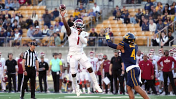 Nov 11, 2023; Berkeley, California, USA; Washington State Cougars quarterback Cameron Ward (1) throws a touchdown pass against California Golden Bears defensive back Kaylin Moore (4) during the fourth quarter at California Memorial Stadium. Mandatory Credit: Darren Yamashita-Imagn Images 