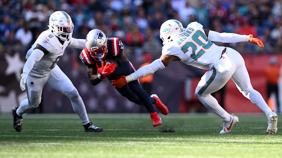 New England Patriots wide receiver DeMario Douglas (3) rushes against Miami Dolphins linebacker Anthony Walker Jr. (6) and linebacker Jordyn Brooks (20) during the second half at Gillette Stadium last season. | Brian Fluharty-Imagn Images