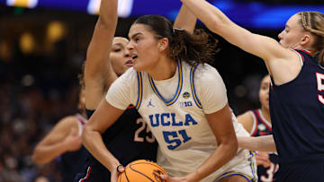 Apr 4, 2025; Tampa, FL, USA;  Connecticut Huskies forward Ice Brady (25) defends against UCLA Bruins center Lauren Betts (51) during second quarter in a semifinal of the women's 2025 NCAA tournament at Amalie Arena. Mandatory Credit: Nathan Ray Seebeck-Imagn Images