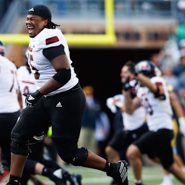 Northern Illinois offensive lineman Abiathar Curry jumps in the air in celebration after winning a NCAA college football game 16-14 against Notre Dame at Notre Dame Stadium on Saturday, Sept. 7, 2024, in South Bend.