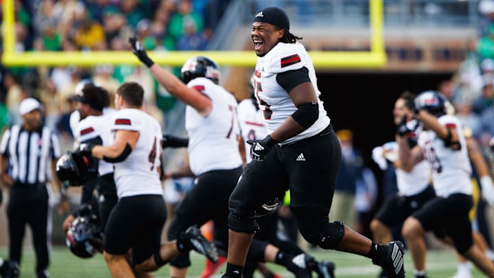 Northern Illinois offensive lineman Abiathar Curry jumps in the air in celebration after winning a NCAA college football game 16-14 against Notre Dame at Notre Dame Stadium on Saturday, Sept. 7, 2024, in South Bend.