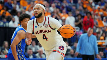 Mar 22, 2025; Lexington, KY, USA;  Auburn Tigers forward Johni Broome (4) drives to the basket against Creighton Bluejays forward Jasen Green (0) during the second half in the second round to the NCAA Tournament at Rupp Arena. Mandatory Credit: Aaron Doster-Imagn Images