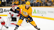Feb 23, 2025; Nashville, Tennessee, USA;  Nashville Predators center Gustav Nyquist (14) skates with the puck against the New Jersey Devils during the third half at Bridgestone Arena. Mandatory Credit: Steve Roberts-Imagn Images