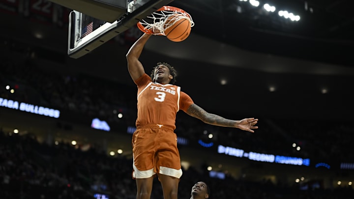 Mar 21, 2026; Portland, OR, USA; Texas Longhorns forward Dailyn Swain (3) dunks against Gonzaga Bulldogs guard Tyon Grant-Foster (7) in a second-round game of the NCAA Tournament.