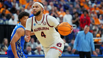 Mar 22, 2025; Lexington, KY, USA;  Auburn Tigers forward Johni Broome (4) drives to the basket against Creighton Bluejays forward Jasen Green (0) during the second half in the second round to the NCAA Tournament at Rupp Arena. Mandatory Credit: Aaron Doster-Imagn Images