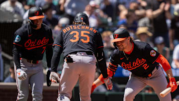 Jun 5, 2025; Seattle, Washington, USA;  Balitimore Orioles designated hitter Adley Rutschman (35) is congratulated by shortstop Gunnar Henderson (2) and second baseman Jackson Holliday (7) after hitting two-run home run during the sixth inning against the Seattle Mariners at T-Mobile Park. 