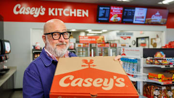 Chef Andrew Zimmern with Casey's BBQ Brisket Pizza