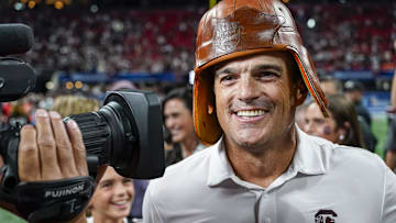 Aug 31, 2025; Atlanta, Georgia, USA; South Carolina Gamecocks head coach Shane Beamer wears the Old Leather Helmet after defeating the Virginia Tech Hokies at Mercedes-Benz Stadium. Mandatory Credit: Dale Zanine-Imagn Images