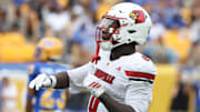 Sep 27, 2025; Pittsburgh, Pennsylvania, USA;  Louisville Cardinals wide receiver Chris Bell (0) celebrates his touchdown against the Pittsburgh Panthers during the second quarter at Acrisure Stadium. Mandatory Credit: Charles LeClaire-Imagn Images