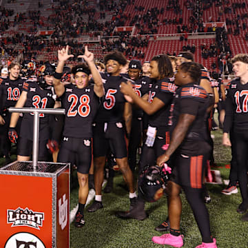 The Utah Utes celebrate a win over the Cincinnati Bearcats after the game at Rice-Eccles Stadium.