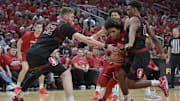 Mar 8, 2025; Louisville, Kentucky, USA;  Louisville Cardinals guard Chucky Hepburn (24) drives to the basket against Stanford Cardinal forward Aidan Cammann (52) and guard Jaylen Blakes (21) during the second half at KFC Yum! Center. Louisville defeated Stanford 68-48. Mandatory Credit: Jamie Rhodes-Imagn Images