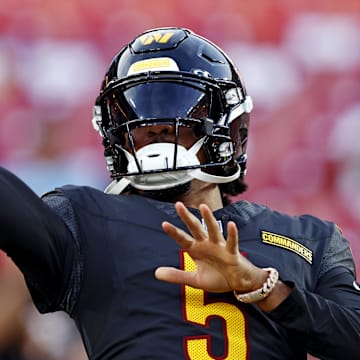 Aug 25, 2024; Landover, Maryland, USA; Washington Commanders quarterback Jayden Daniels (5) warms up before playing a preseason game against the New England Patriots at Commanders Field. Mandatory Credit: Peter Casey-Imagn Images