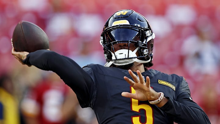 Aug 25, 2024; Landover, Maryland, USA; Washington Commanders quarterback Jayden Daniels (5) warms up before playing a preseason game against the New England Patriots at Commanders Field. Mandatory Credit: Peter Casey-Imagn Images