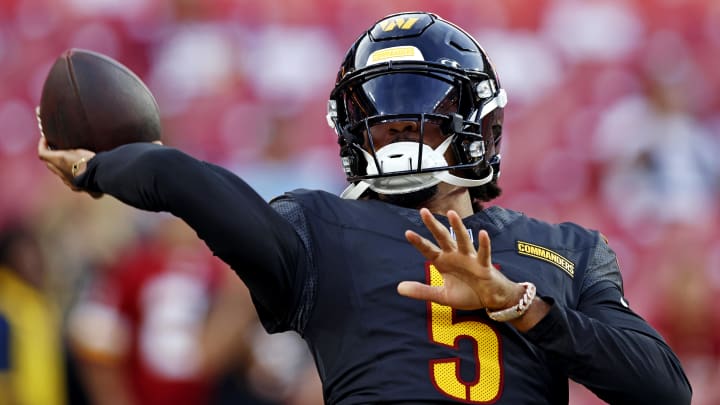 Aug 25, 2024; Landover, Maryland, USA; Washington Commanders quarterback Jayden Daniels (5) warms up before playing a preseason game against the New England Patriots at Commanders Field. Mandatory Credit: Peter Casey-USA TODAY Sports