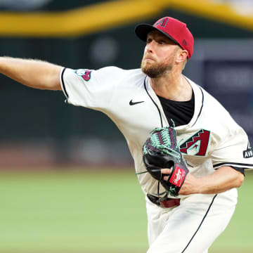 Apr 15, 2024; Phoenix, Arizona, USA; Arizona Diamondbacks pitcher Merrill Kelly pitches against the Chicago Cubs during the first inning at Chase Field. All players wore number 42 to commemorate Jackie Robinson Day. Mandatory Credit: Joe Camporeale-USA TODAY Sports