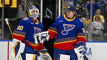 Mar 13, 2024; St. Louis, Missouri, USA;  St. Louis Blues goaltender Jordan Binnington (50) celebrates with goaltender Joel Hofer (30) after the Blues defeated the Los Angeles Kings at Enterprise Center. Mandatory Credit: Jeff Curry-Imagn Images