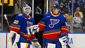 Mar 13, 2024; St. Louis, Missouri, USA;  St. Louis Blues goaltender Jordan Binnington (50) celebrates with goaltender Joel Hofer (30) after the Blues defeated the Los Angeles Kings at Enterprise Center. Mandatory Credit: Jeff Curry-Imagn Images