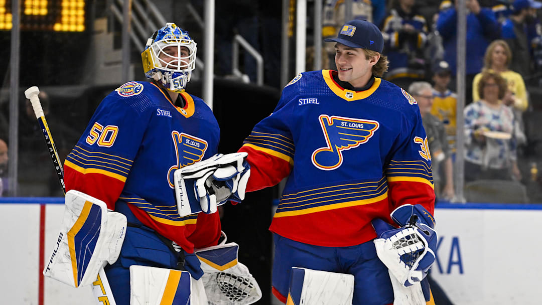 Mar 13, 2024; St. Louis, Missouri, USA;  St. Louis Blues goaltender Jordan Binnington (50) celebrates with goaltender Joel Hofer (30) after the Blues defeated the Los Angeles Kings at Enterprise Center. Mandatory Credit: Jeff Curry-Imagn Images