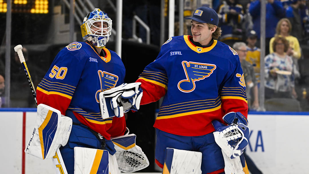 Mar 13, 2024; St. Louis, Missouri, USA;  St. Louis Blues goaltender Jordan Binnington (50) celebrates with goaltender Joel Hofer (30) after the Blues defeated the Los Angeles Kings at Enterprise Center. Mandatory Credit: Jeff Curry-Imagn Images