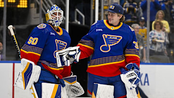Mar 13, 2024; St. Louis, Missouri, USA;  St. Louis Blues goaltender Jordan Binnington (50) celebrates with goaltender Joel Hofer (30) after the Blues defeated the Los Angeles Kings at Enterprise Center. Mandatory Credit: Jeff Curry-Imagn Images