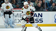 Nov 14, 2024; Seattle, Washington, USA;  Chicago Blackhawks defenseman Seth Jones (4) skates with the puck against the Seattle Kraken at Climate Pledge Arena. Mandatory Credit: Stephen Brashear-Imagn Images