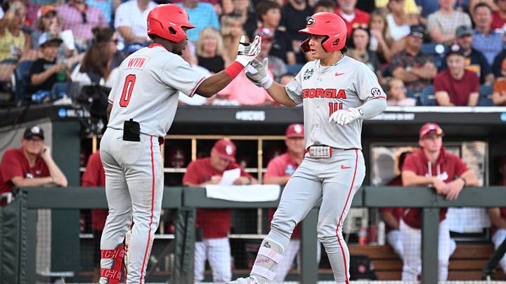 Jun 15, 2026; Omaha, NE, USA; Georgia Bulldogs left fielder Kenny Ishikawa (14) greets second baseman Ryan Wynn (0) after hitting a home run against the Oklahoma Sooners during the first inning at Charles Schwab Field. Mandatory Credit: Steven Branscombe-Imagn Images
