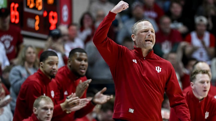 Jan 4, 2026; Bloomington, Indiana, USA; Indiana Hoosiers head coach Darian Devries celebrates after a play against the Washington Huskies during the second half at Simon Skjodt Assembly Hall. Mandatory Credit: Robert Goddin-Imagn Images