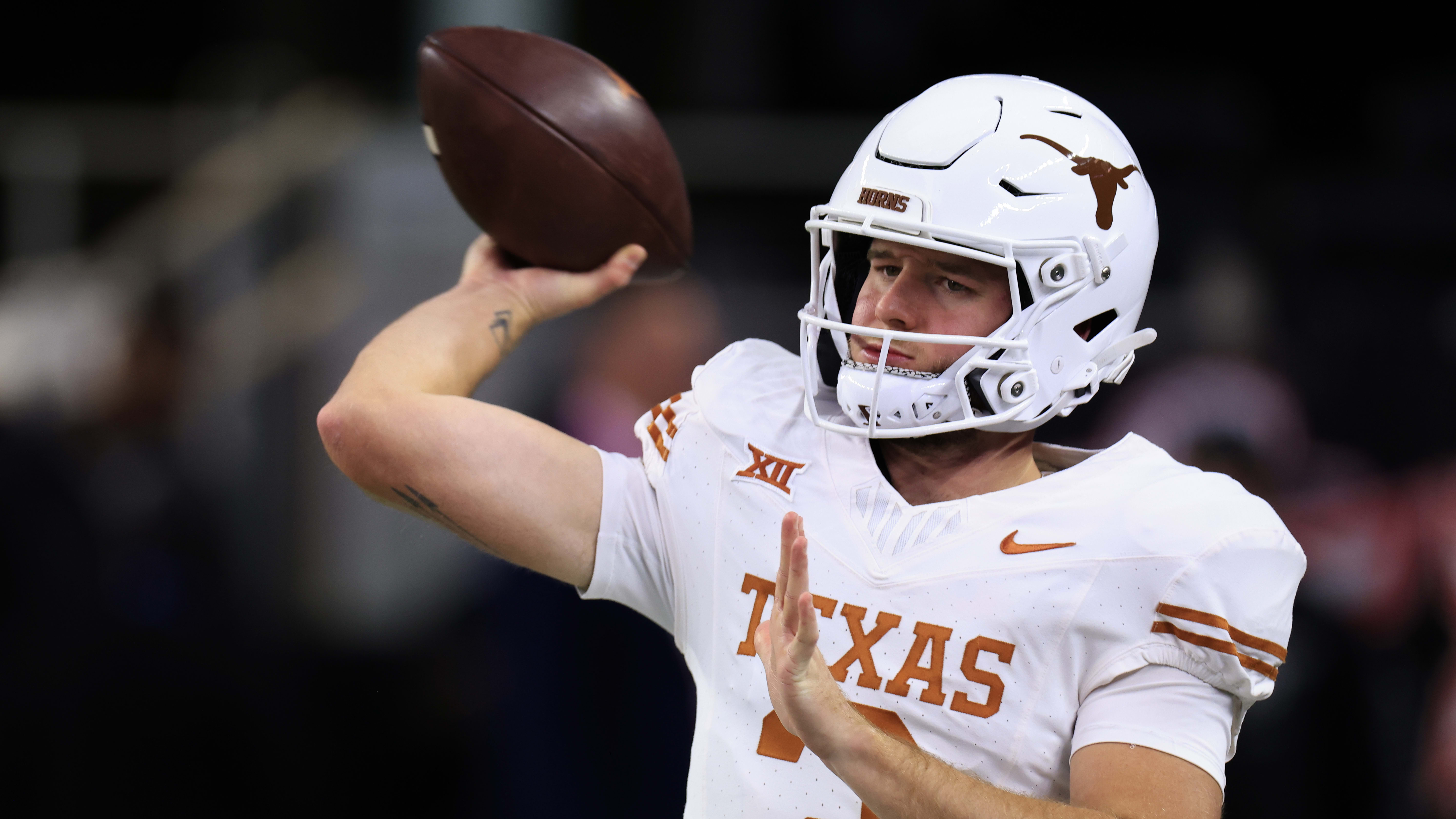 Texas Longhorns quarterback Quinn Ewers attempts a pass during a college football game in the SEC.