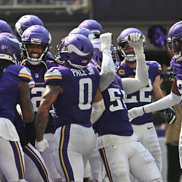 Sep 15, 2024; Minneapolis, Minnesota, USA; The Minnesota Vikings react after an interception by safety Josh Metellus (obscured in center) against the San Francisco 49ers during the third quarter U.S. Bank Stadium.